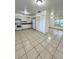 Bright kitchen featuring ample cabinet space, and large tile flooring at 302 W Rose Ln, Lady Lake, FL 32159