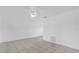 Bright living room with ceramic tile, ceiling fan, and fresh paint at 302 W Rose Ln, Lady Lake, FL 32159