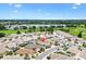 Aerial view of a neighborhood featuring lush landscaping and a golf course at 3105 Carrollton Ct, The Villages, FL 32162