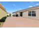 Backyard featuring a well-maintained patio, a grill, a garden, and views of the surrounding neighborhood at 3105 Carrollton Ct, The Villages, FL 32162