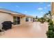 Beautifully landscaped backyard featuring a patio, grill, and various plants at 3105 Carrollton Ct, The Villages, FL 32162