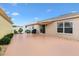 Spacious backyard with patio, grill, and awning, perfect for entertaining or relaxing outdoors at 3105 Carrollton Ct, The Villages, FL 32162