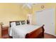 Cozy bedroom with yellow walls, a ceiling fan, and a closet with sliding doors at 3105 Carrollton Ct, The Villages, FL 32162