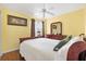 This primary bedroom features light yellow walls, a ceiling fan, and a decorative dresser at 3105 Carrollton Ct, The Villages, FL 32162