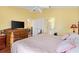 The bedroom features hardwood floors, a ceiling fan, and an ensuite bathroom at 3105 Carrollton Ct, The Villages, FL 32162