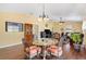Comfortable dining area featuring a glass table, hardwood floors, and open view into the living room at 3105 Carrollton Ct, The Villages, FL 32162