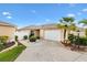 Charming single-Gathering home featuring an attached garage and beautiful landscaping on a sunny day at 3105 Carrollton Ct, The Villages, FL 32162