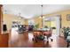 Open-concept living room with hardwood floors, ceiling fan, and sliding glass doors to the patio at 3105 Carrollton Ct, The Villages, FL 32162