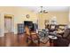 Spacious living room with hardwood floors, ceiling fan, and comfortable leather furniture at 3105 Carrollton Ct, The Villages, FL 32162