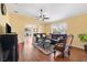 Bright living room with hardwood floors, ceiling fan, and comfortable leather seating area at 3105 Carrollton Ct, The Villages, FL 32162
