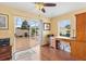 Bright office space with hardwood floors, desk, and sliding glass door to a screened patio at 3105 Carrollton Ct, The Villages, FL 32162