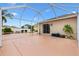 Large screened-in patio with a concrete floor and a view of the backyard at 3105 Carrollton Ct, The Villages, FL 32162