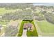 Aerial view of property boundary with house, lush landscaping, and open spaces at 321 Watershore Dr, Leesburg, FL 34748