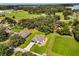 Aerial view of the home with a well manicured lawn and mature trees at 321 Watershore Dr, Leesburg, FL 34748