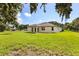 A lush backyard with a freshly built home on a sunny day at 321 Watershore Dr, Leesburg, FL 34748
