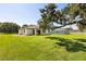 Expansive backyard featuring a modern home design, and mature trees at 321 Watershore Dr, Leesburg, FL 34748