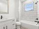Modern bathroom features white marble tile in shower, and sleek black fixtures at 321 Watershore Dr, Leesburg, FL 34748
