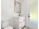 Bathroom showcasing a marble countertop vanity, gold mirror and modern black hardware at 321 Watershore Dr, Leesburg, FL 34748