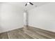 Bright bedroom features wood-look floors and white walls, creating a modern aesthetic at 321 Watershore Dr, Leesburg, FL 34748