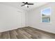 Bedroom boasts wood-look floors, a sliding door closet, and natural light from the window at 321 Watershore Dr, Leesburg, FL 34748