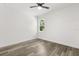 Bright bedroom featuring wood-look floors, a ceiling fan and a window with a view at 321 Watershore Dr, Leesburg, FL 34748