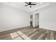 Spacious bedroom featuring wood flooring, ample natural light, and modern ceiling fan at 321 Watershore Dr, Leesburg, FL 34748
