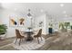 Open dining area with stylish furnishings, elegant lighting, and seamless flow to the living room and kitchen at 321 Watershore Dr, Leesburg, FL 34748