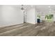 Spacious open room with wood-look floors, recessed lighting, and views of the kitchen and backyard at 321 Watershore Dr, Leesburg, FL 34748