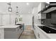Well-equipped kitchen featuring an island with a sink and stainless steel appliances, including double wall ovens at 321 Watershore Dr, Leesburg, FL 34748