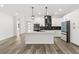 Bright kitchen boasts white cabinets, stainless steel appliances, and a center island with bar seating at 321 Watershore Dr, Leesburg, FL 34748