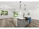 Stylish kitchen island with a black sink, modern faucet and stainless steel appliances at 321 Watershore Dr, Leesburg, FL 34748