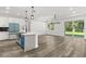 Open living area featuring modern cabinetry, a kitchen island, and views of the backyard, enhancing the interior space at 321 Watershore Dr, Leesburg, FL 34748