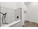 A well-lit pet shower area with white tiling and black fixtures at 321 Watershore Dr, Leesburg, FL 34748