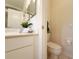 Clean bathroom featuring a white vanity, decorative towels, and toilet at 3416 Capland Ave, Clermont, FL 34711