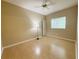 Bright bedroom with laminate flooring, ceiling fan, and closet space at 3416 Capland Ave, Clermont, FL 34711