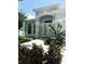 Charming front exterior featuring a garden, walkway, and covered porch at 3416 Capland Ave, Clermont, FL 34711