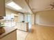 Open kitchen features white cabinetry, a central island, a tile floor, and seamlessly merges with the adjacent living area at 3416 Capland Ave, Clermont, FL 34711