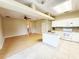 Open concept kitchen featuring white cabinets, center island, tile flooring, and seamlessly connects to the living area at 3416 Capland Ave, Clermont, FL 34711
