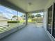 Enclosed lanai with views of well-manicured backyard and blue skies at 3416 Capland Ave, Clermont, FL 34711