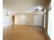 Inviting living room featuring neutral walls, hardwood floors, closet, and arched entryway at 3416 Capland Ave, Clermont, FL 34711
