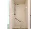 Walk-in shower featuring tiled walls, shower head, grab bar and tiled bench at 3416 Capland Ave, Clermont, FL 34711