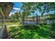 Spacious backyard featuring a trampoline, lush greenery, and shade trees at 35338 Lake Unity Rd, Fruitland Park, FL 34731