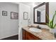 Bathroom vanity with framed mirror and granite countertop with view to wood-look flooring at 35338 Lake Unity Rd, Fruitland Park, FL 34731
