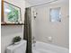 Bright bathroom featuring shower with tile surround, a shower curtain, and a framed art print at 35338 Lake Unity Rd, Fruitland Park, FL 34731