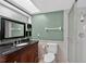 Bathroom featuring wainscoting, dark wood vanity, and a stand-up shower at 35338 Lake Unity Rd, Fruitland Park, FL 34731