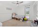 Bright bedroom with carpeted floor, a ceiling fan, and a large window with natural light at 35338 Lake Unity Rd, Fruitland Park, FL 34731