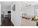 View from hallway into bedroom with ceiling fan, carpeted floors, and natural light at 35338 Lake Unity Rd, Fruitland Park, FL 34731