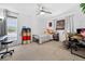 Bedroom with ceiling fan, two windows, and desk area with natural light at 35338 Lake Unity Rd, Fruitland Park, FL 34731
