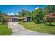 Charming home exterior showcasing a well-manicured lawn and driveway at 35338 Lake Unity Rd, Fruitland Park, FL 34731