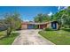 Charming single-story home with a long driveway and brick and blue paneled accents at 35338 Lake Unity Rd, Fruitland Park, FL 34731